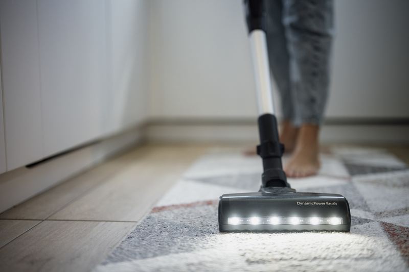 Person vacuuming a home floor